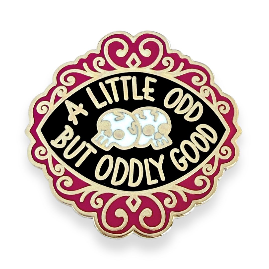 Pin with 'A Little Odd But Oddly Good' text and skull design on a white background