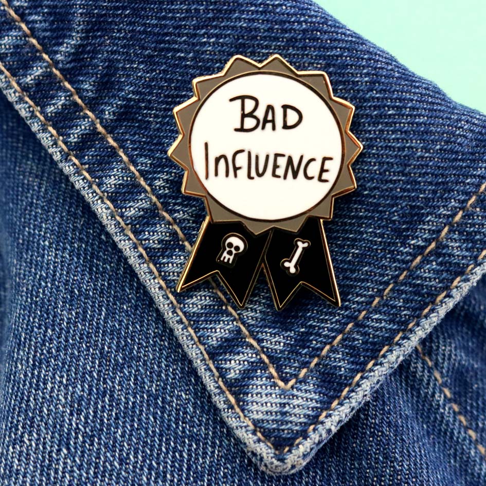 Bad Influence Lapel Pin on a denim jacket lapel