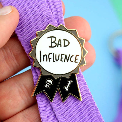 Bad Influence Lapel Pin on a lanyard
