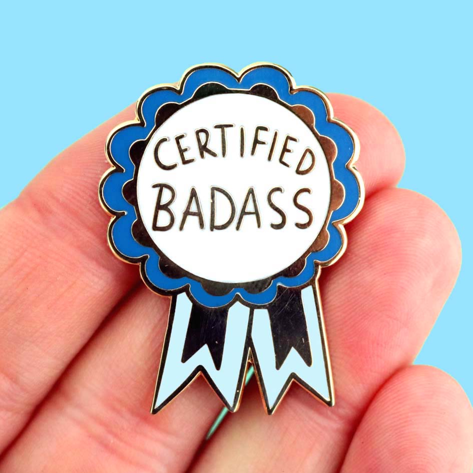 Hand holding Certified Badass Lapel Pin