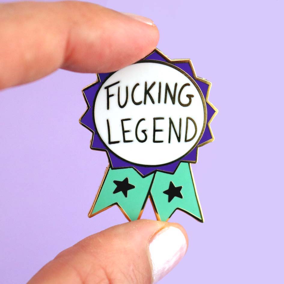 Fucking Legend Lapel Pin held by fingers