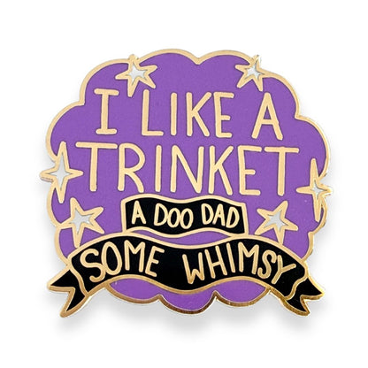 Purple and gold enamel pin with I like a trinket, a doo-dad, some whimsy design on a cloud background