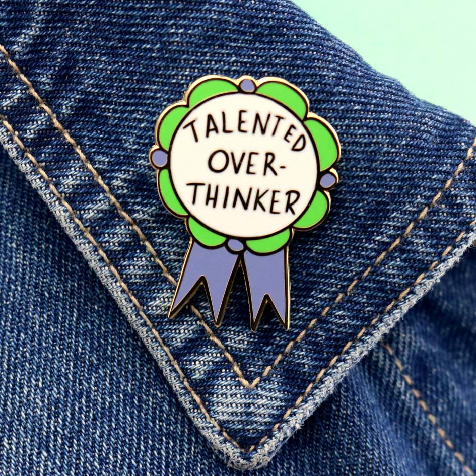 Talented Over Thinker Lapel Pin on a denim jacket lapel